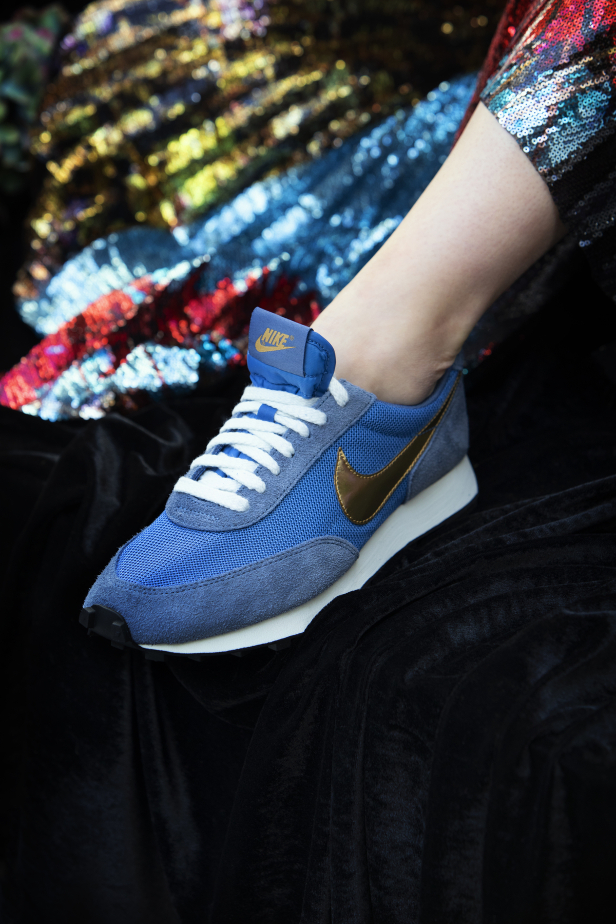 Close up of blue Nike trainers with gold detailing